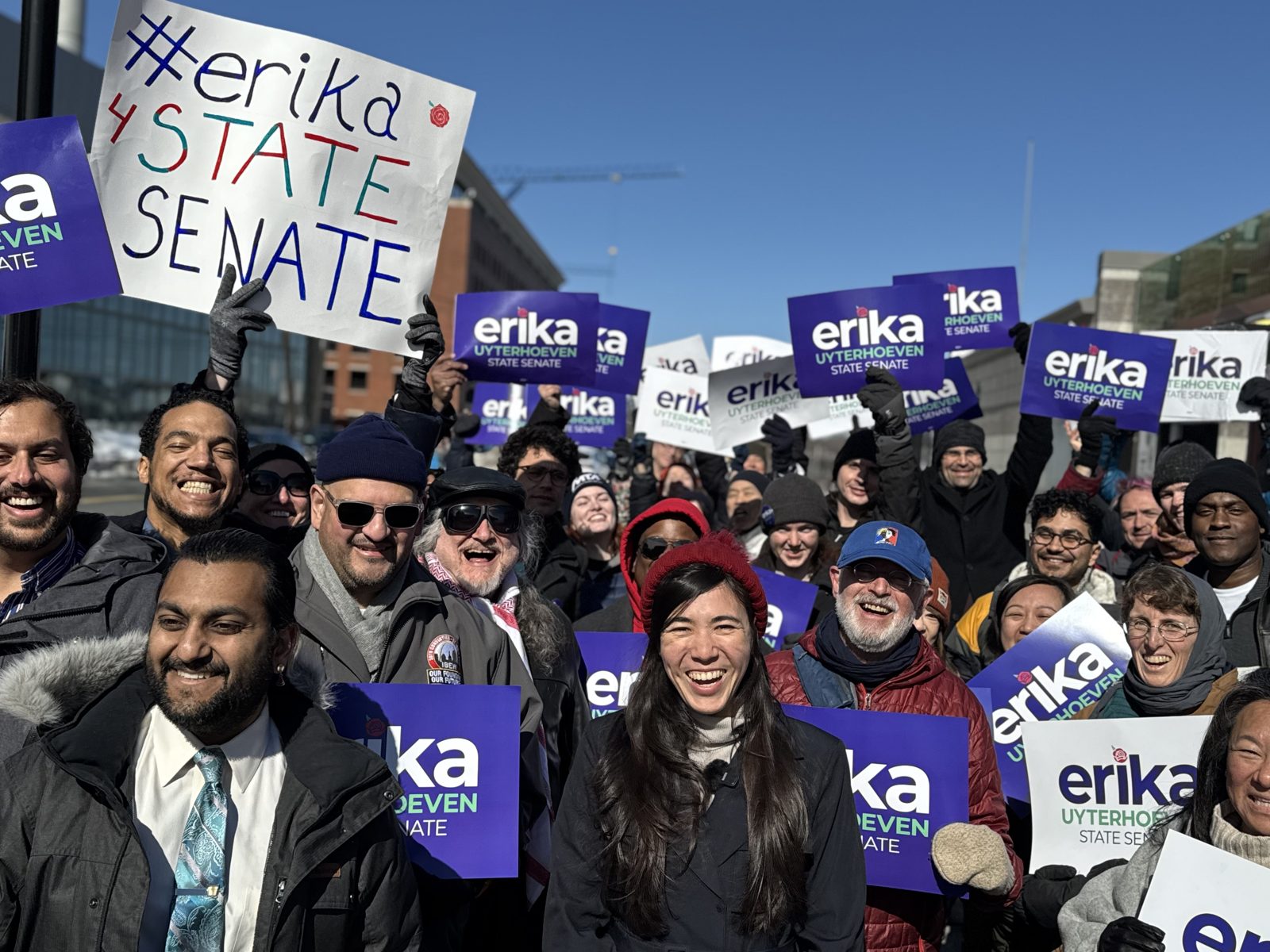 Erika with a crowd of supporters holding Erika Uyterhoeven for State Senate signs