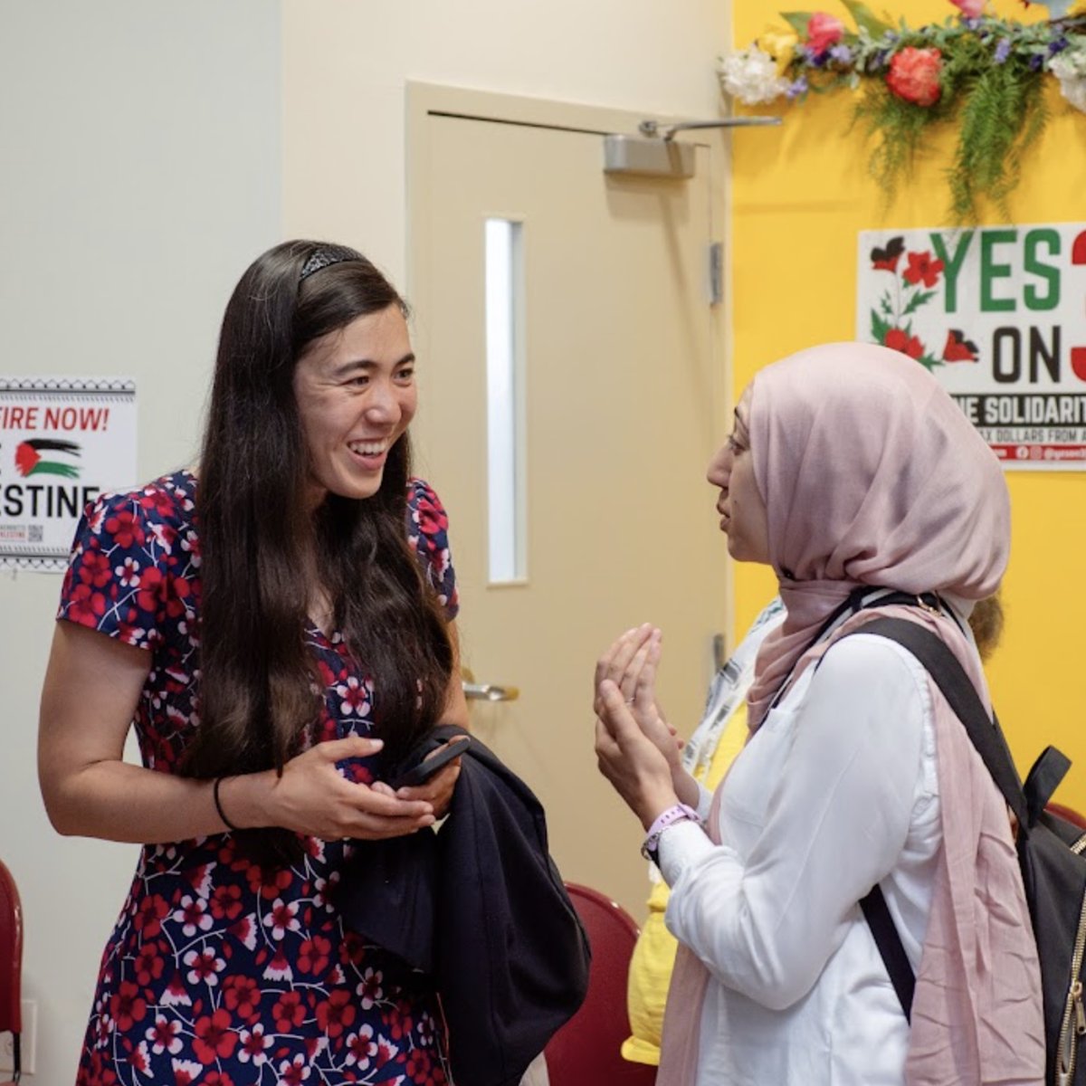 Erika in conversation with a neighbor at a community event
